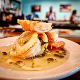 Driftwood Kitchen signature dishes Shrimp and Grits, Crab Cake Sandwich, Fish and Chips, seasonal entrees